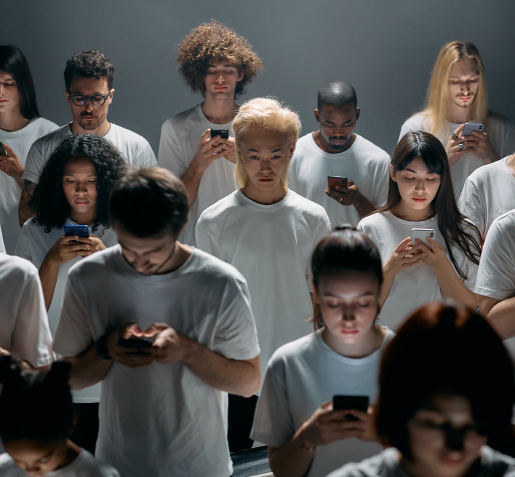 crowd of people looking at phones
