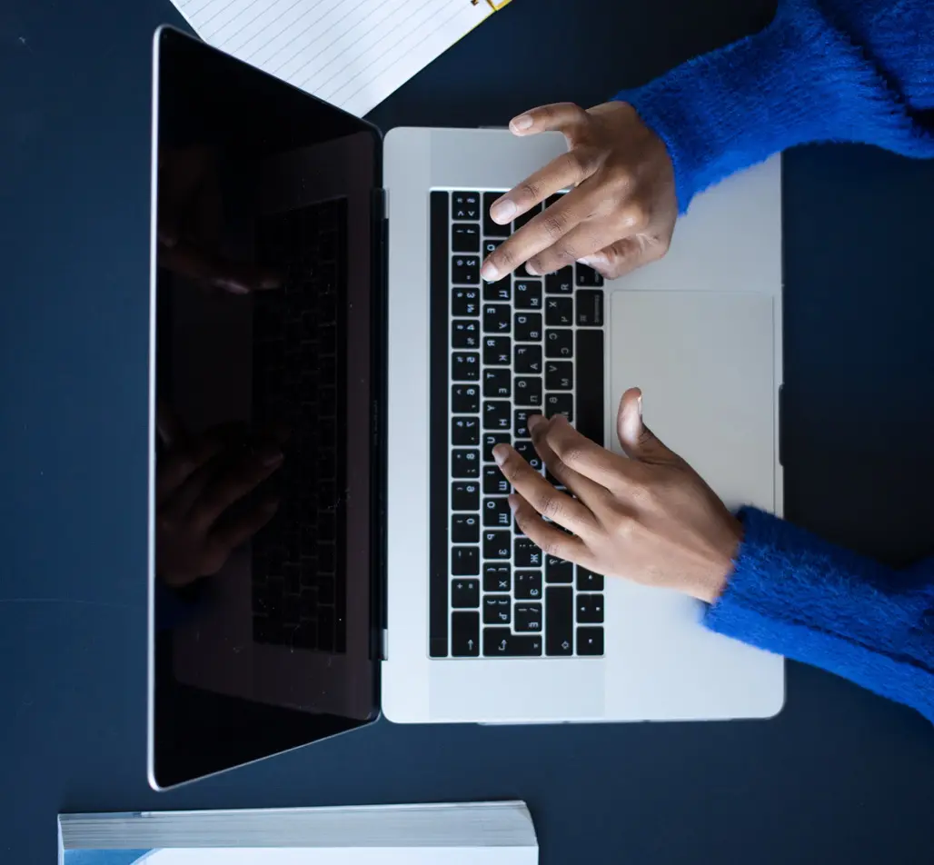 hands on a laptop keyboard from above