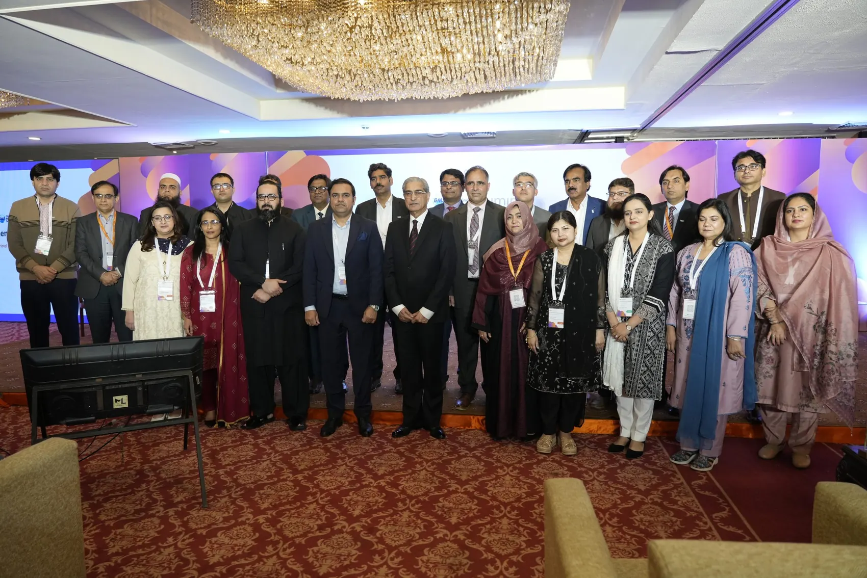 Chughtai Lab, formal group photo at banquet hall with chandelier