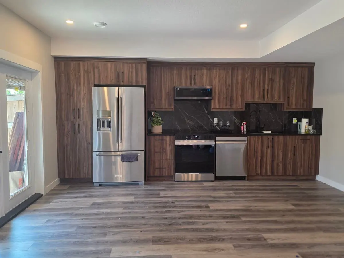 Grains Construction, basement kitchen with dark cabinets and stainless appliances