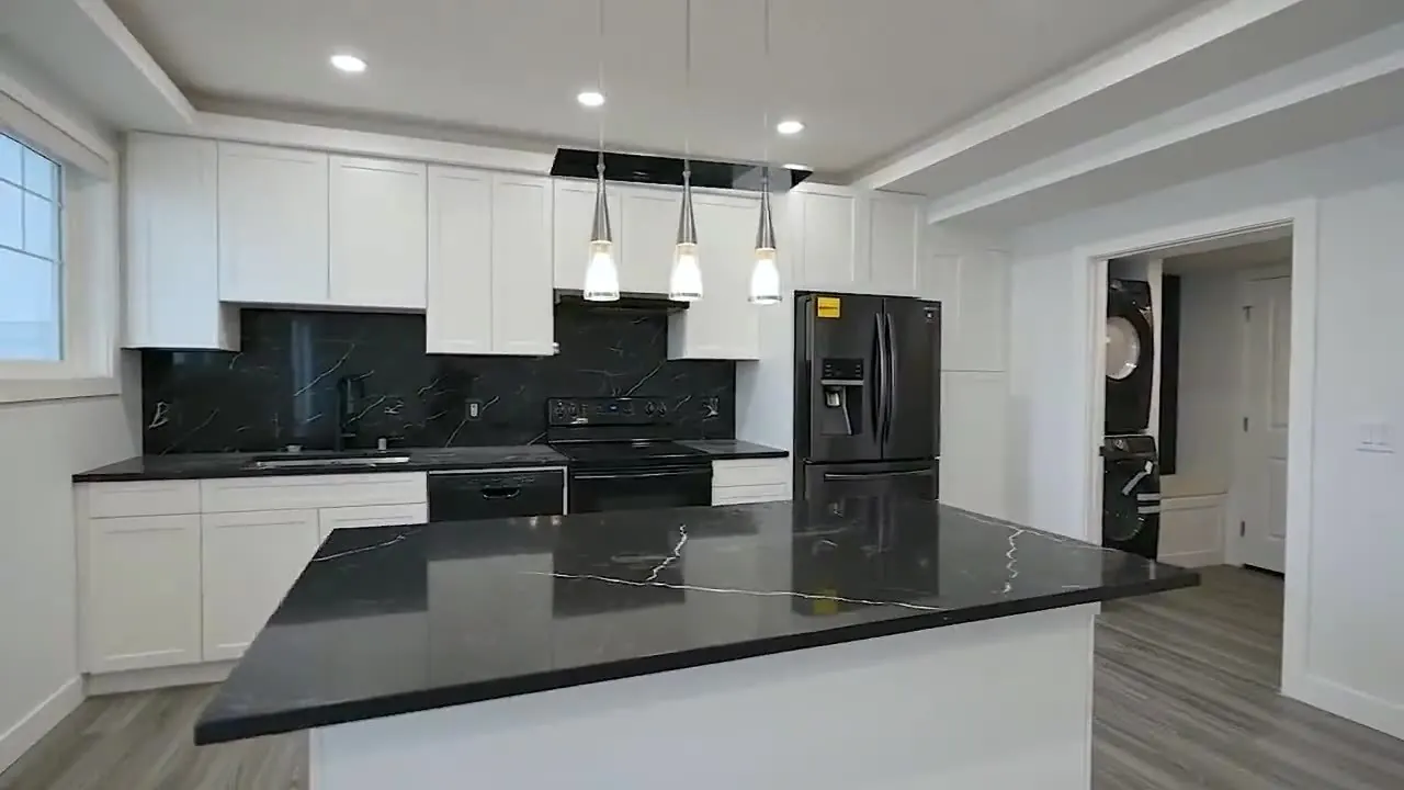 Grains Construction, finished kitchen with black cabinets and appliances